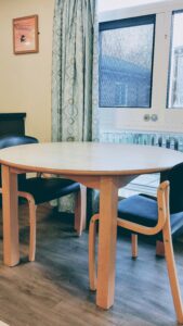 A table and two chairs by a window