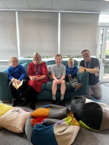 Anna Hodgson, senior clinician, with Rob Berry, Wellbeing in Mind service manager, and three pupils from Clifton Green Primary School.