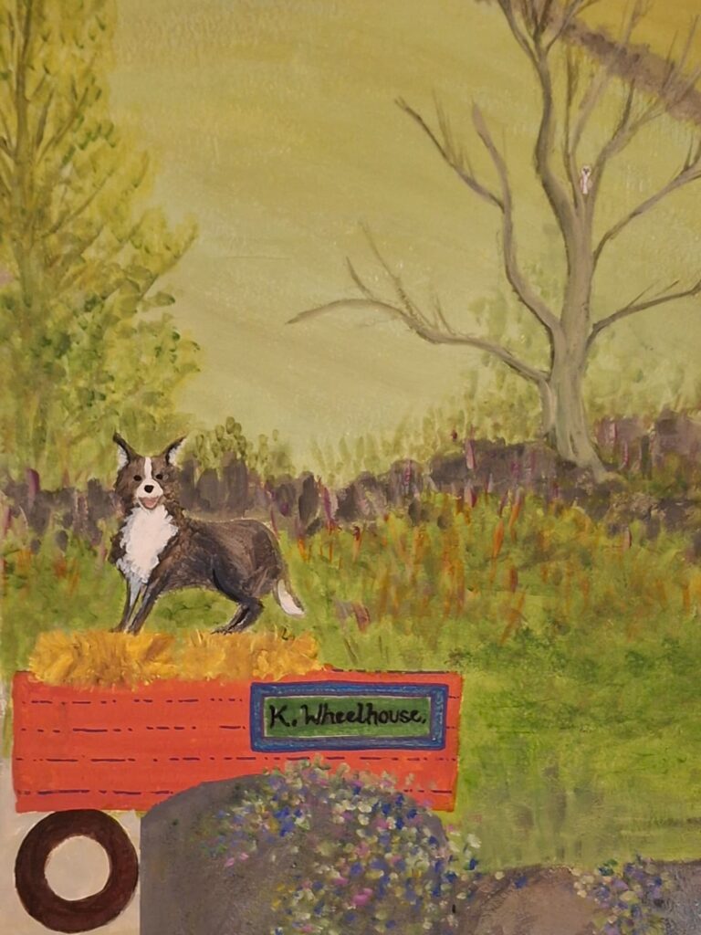 Close up of a collie dog on top of a red trailer and hay