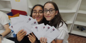 Sabela and Inés from the British School of Valencia in Spain smiling with letters of hope.